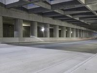 an empty parking garage with no people in it at night time time with only one stop sign