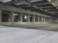 an empty parking garage with no people in it at night time time with only one stop sign