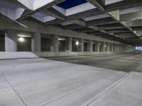 an empty parking garage with no people in it at night time time with only one stop sign
