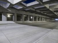 an empty parking garage with no people in it at night time time with only one stop sign