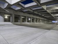 an empty parking garage with no people in it at night time time with only one stop sign