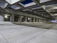 an empty parking garage with no people in it at night time time with only one stop sign