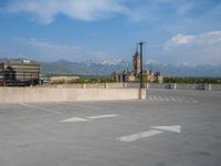 several large empty parking spaces in the city with buildings nearby in front of them -