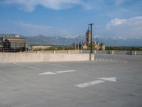 several large empty parking spaces in the city with buildings nearby in front of them -