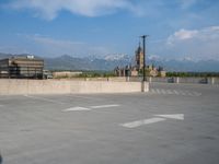 several large empty parking spaces in the city with buildings nearby in front of them -