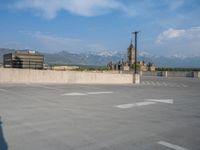 several large empty parking spaces in the city with buildings nearby in front of them -