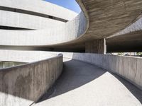 this building is designed like a spiral staircase with concrete surfaces, and the walls are lined in arches