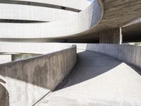 this building is designed like a spiral staircase with concrete surfaces, and the walls are lined in arches