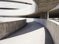 this building is designed like a spiral staircase with concrete surfaces, and the walls are lined in arches