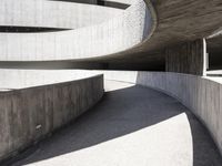 this building is designed like a spiral staircase with concrete surfaces, and the walls are lined in arches