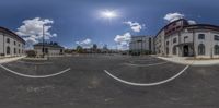 this is a panoramic image of some buildings in front of a parking lot