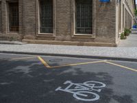 the side walk and walkway of a building is marked with markings for parking spaces below