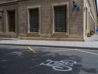 the side walk and walkway of a building is marked with markings for parking spaces below