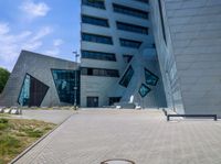 view of entrance and building from inside the building on a sunny day at an office complex