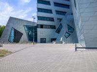 view of entrance and building from inside the building on a sunny day at an office complex