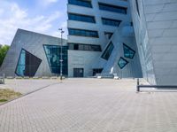 view of entrance and building from inside the building on a sunny day at an office complex