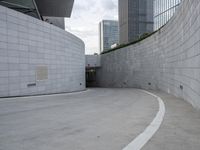 a skateboarder rides through a parking lot in front of buildings in the city