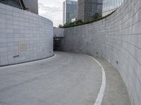 a skateboarder rides through a parking lot in front of buildings in the city