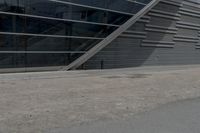 an image of a man riding on a skateboard in front of a building near the street