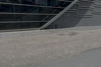 an image of a man riding on a skateboard in front of a building near the street