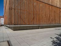 a group of people riding skateboards near wooden panels and stairss with artwork on them