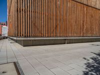 a group of people riding skateboards near wooden panels and stairss with artwork on them