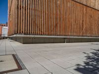 a group of people riding skateboards near wooden panels and stairss with artwork on them