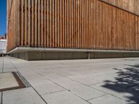 a group of people riding skateboards near wooden panels and stairss with artwork on them