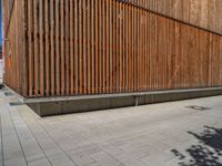 a group of people riding skateboards near wooden panels and stairss with artwork on them