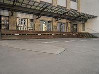 an empty building with signs on the street and people on bikes in traffic passing by