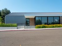 the building has glass doors that look like a small group of buildings in front of it