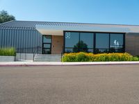 the building has glass doors that look like a small group of buildings in front of it