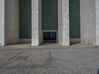 there are columns standing next to each other in an open area with cobblestone