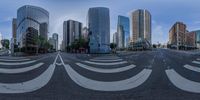 an intersection with buildings behind and empty road in front of it's corner, and with a view of the sky