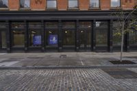 a sidewalk with two buildings in the background, and a sign on one of the buildings that says, ` we're open from 2pmercept '