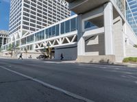 a long empty street is lined with tall buildings and cars that have stopped on it