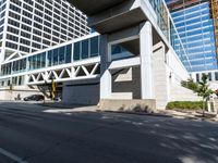 a long empty street is lined with tall buildings and cars that have stopped on it