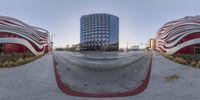 a person skateboarding in a very circular mirror like setting next to a skyscraper that appears to be made of a red stripe