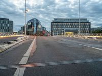 empty city street with traffic lights at night and building in the background in urban area