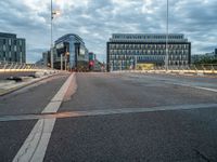 empty city street with traffic lights at night and building in the background in urban area