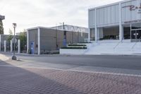 the corner of a street has steps to be opened up and has steps leading up to an entrance on either side