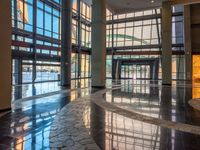 large lobby with tiled floor and windows with large glass wall on the side of it