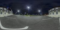 360 - angle picture of a road with a parking lot in the middle and streetlights above