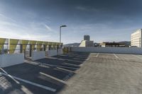 a parking garage in an outdoor commercial space with a view over city buildings and buildings