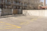 an empty parking lot with multiple markings for parking spots on it and no people walking