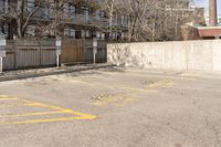 an empty parking lot with multiple markings for parking spots on it and no people walking