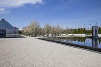 an outdoor pool with stairs leading to a building with a pyramid and a triangle shaped structure