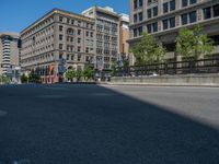 an empty street with buildings and parked cars on the sidewalks and green lanes on the sidewalk