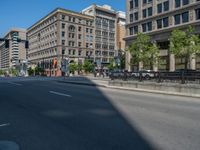 an empty street with buildings and parked cars on the sidewalks and green lanes on the sidewalk