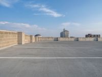 several large empty parking spaces in the city with buildings nearby in front of them -